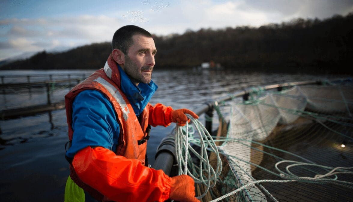 worker on salmon farm in rural lake 2022 03 07 23 55 43 utc - Environment